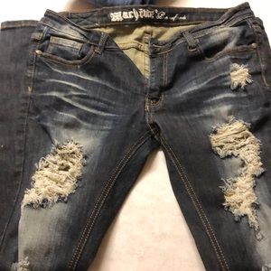 Distressed machine jeans